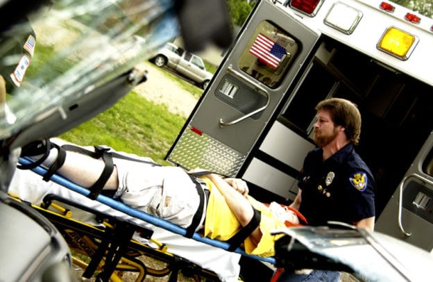 EMT wheeling someone on a stretcher